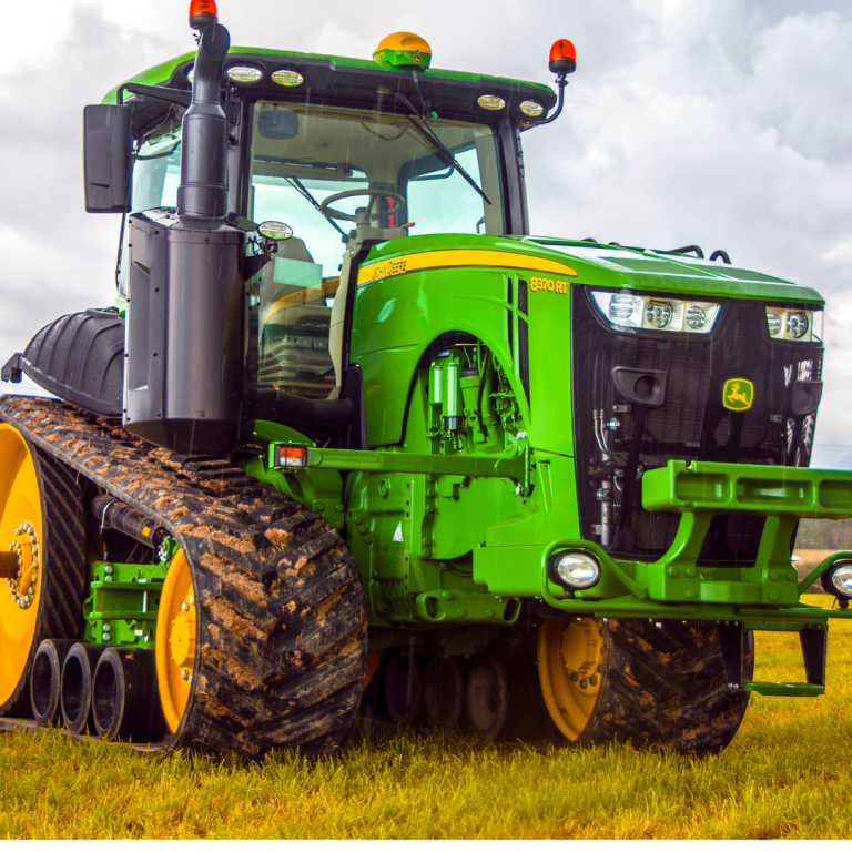 Green tractor in a field representing agricultural asset finance