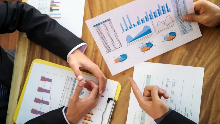 Team discussing financial reports and business growth charts for a business venture