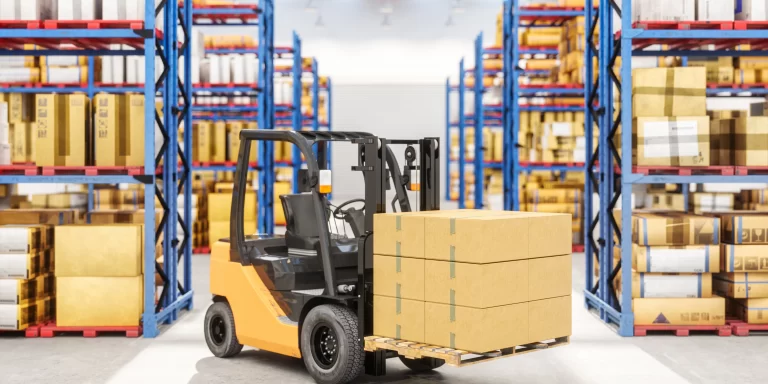 Forklift moving boxes in warehouse representing asset finance and its tax benefits for businesses