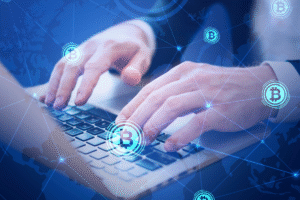 Hands typing on laptop with blockchain and bitcoin icons, representing digital finance and secure business lending